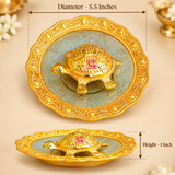 Size guide image for Handcrafted Brass Tortoise Plate showing approximate dimensions of 5.5 inches diameter and 1 inch height. The image clearly displays the decorative brass tortoise plate from top and side angles with measurement arrows, highlighting the scalloped decorative edge, embossed plate surface and raised tortoise centerpiece on a premium beige background.