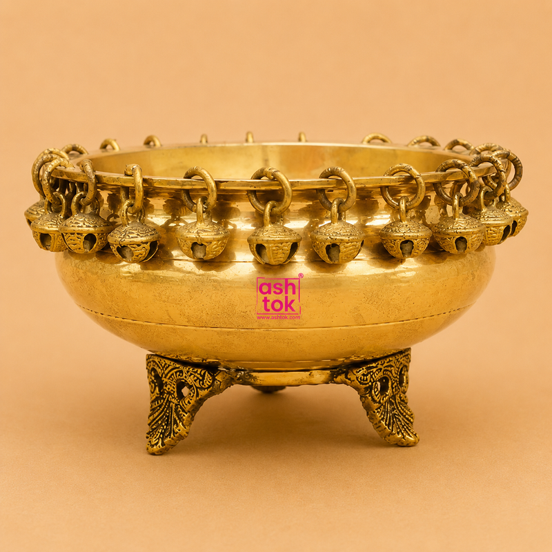 Handcrafted brass urli with decorative hanging bells and ornate legs, perfect for floating flowers, candles, pooja rituals, Diwali décor, weddings, housewarming, and traditional home decoration.