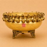 Handcrafted brass urli with decorative hanging bells and ornate legs, perfect for floating flowers, candles, pooja rituals, Diwali décor, weddings, housewarming, and traditional home decoration.