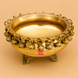 Handcrafted brass urli with decorative hanging bells and ornate legs, ideal for floating flowers, candles, festive décor, pooja, Diwali, weddings, housewarming, and traditional home decoration.