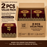 Bulk order 2 pcs value pack graphic for Ashtok handcrafted wooden maroon velvet storage boxes. The image displays an open brown shipping box containing 2 individual maroon velvet jewellery boxes side-by-side, with a third sample box placed outside the carton. Text overlay highlights '2 PCS VALUE PACK - Handcrafted Wooden Velvet Storage', individual premium packaging details, and safe delivery icons.