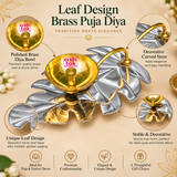 Professional product features image showcasing the distinctive design of a Leaf Design Brass Puja Diya with a polished golden brass bowl, decorative curved golden stem, and reflective silver-coloured leaf-shaped tray. The central brass oil lamp bowl features a smooth circular opening, carefully finished rounded edges, concentric circular patterns on the inner surface, and a raised cylindrical wick holder positioned at the centre. The decorative leaf-shaped base features multiple sculpted lobes, gracefully c