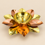 Brass and copper lotus diya raw product image on a soft beige background, showing a decorative akhand diya designed in a lotus flower shape with alternating brass-toned and copper-toned petals, a round central oil holder, and a traditional handcrafted finish, ideal for pooja décor, festive decoration, return gifts, and traditional gifting for Diwali, Navratri, housewarming, weddings, and spiritual occasions.