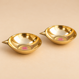 Top view of a set of 2 Matt Finish Brass Pankti Diyas showing the circular shallow bowl shape, smooth inner surface and pointed spouts. The overhead angle clearly displays the traditional diya form and brass finish.