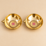 Top view of a set of 2 Matt Finish Brass Pankti Diyas showing the circular shallow bowl shape, smooth inner surface and pointed spouts. The overhead angle clearly displays the traditional diya form and brass finish.