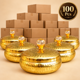 Bulk display of 100 metal dryfruit gift boxes shown with plain stacked boxes in the background and sample golden containers in front, suitable for wholesale orders, wedding return gifts, festive gifting, event distribution and large quantity gift requirements.