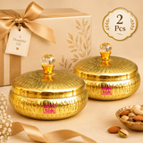 Set of 2 metal dryfruit gift boxes presented in a premium gifting setup with elegant packaging, featuring matching golden hammered containers with fitted lids and crystal-style knobs, suitable for return gifts, festive gifting, housewarming and special occasions.