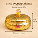 Size guide image for metal dryfruit gift box showing approximately 5 inches diameter and 3 inches height, with the round golden storage box, fitted lid and crystal-style top knob clearly presented on a premium beige background for easy dimension reference.