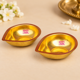 Top view of two Brass Pankti Puja Diyas showing their distinctive rounded leaf-shaped design, reflective golden brass interiors and copper-toned borders.