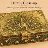 Close-up view of the peacock design decorative storage box highlighting the raised golden peacock artwork, multicolour decorative stone-style detailing, embossed border pattern and ornate metal clasp craftsmanship.