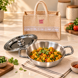Prestige Triply Kadai with Lid 1.2 L 9 inch with bag shown in kitchen lifestyle setting with cooked food
