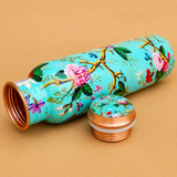 Printed copper water bottle with floral design and open copper cap, featuring a leak-proof threaded lid and decorative finish for Ayurvedic water storage.