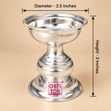 Size guide for a traditional silver finish Puja Deepam showing approximately 2.5 inch diameter across the upper bowl and 3 inch overall height from the top rim to the bottom of the circular pedestal base, with clear measurement arrows on a premium beige background, useful for understanding the compact size and proportions before purchase for daily puja, mandir use, gifting and festive worship.