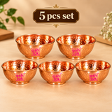Set of 5 pure copper hammered bowls arranged neatly on a premium beige studio background, suitable for festive serving, family dining, gifting and special occasions.