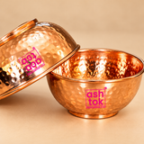 Detailed close-up of pure copper hammered bowls highlighting the hand-hammered texture, smooth polished interior, rolled rim, rounded bowl shape and warm natural copper finish.