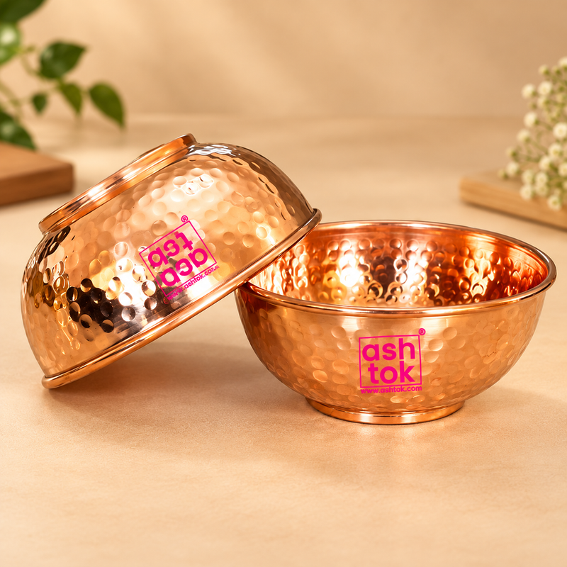 Pure copper hammered bowls with a warm polished finish, rounded serving shape and traditional hammered texture, presented on a premium beige studio background for serving, puja use and gifting.