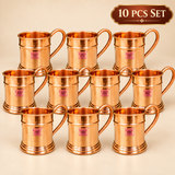 Set of 10 pure copper mugs displayed in an organized studio arrangement, featuring matching polished copper bodies and curved handles, suitable for restaurants, events, parties, gifting and bulk drinkware requirements.