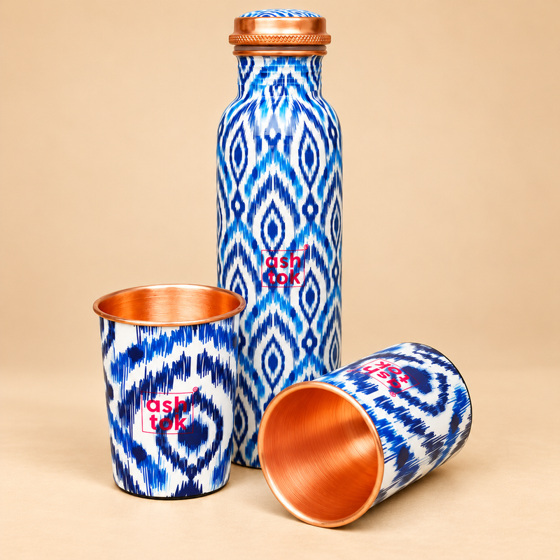 Blue printed pure copper water bottle with two matching glasses shown from an alternate angle