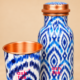 Close-up view of blue printed pure copper water bottle and matching glass showing finish and pattern details