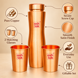 Product features infographic of a pure copper water bottle with two matching drinking glasses highlighting pure copper construction, secure screw cap, smooth satin finish, coordinated copper glasses, everyday usability and suitability for gifting. The three-piece copper drinkware set is displayed against a warm beige studio background.