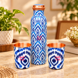 Pure copper water bottle with 2 matching glasses styled in a home setting for everyday water serving
