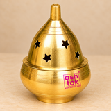 Front-angle product photograph of Brass Piyali Akhand Deep featuring an elegant golden brass finish, conical removable cover with star-shaped openings, engraved circular detailing, smooth rounded oil container, and a stable circular base. This traditional akhand jyoti diya is designed for daily pooja, home mandir decoration, festive religious ceremonies, and devotional worship.
