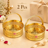 Set of 2 Round Shaped Brass Puja Baskets, Phool Butti Flower Baskets displayed together in a premium beige gifting setup. Each golden basket features decorative floral cutwork, embossed Om detailing, sturdy curved handle and visible ASHTOK branding, making the two-piece set suitable for festive gifting, housewarming gifts, religious functions, temple use, wedding gifts and traditional return gift requirements.