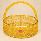 Round shaped metal wire flower basket featuring a bright golden finish, circular woven wire body, decorative openwork construction and tall curved handle, professionally displayed on a premium beige studio background for gifting, flower presentation and decorative use.