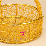Detailed close-up of round metal wire flower basket highlighting the intricate woven wire pattern, polished golden finish, reinforced circular rim, decorative handle texture and side attachment details, showing the fine craftsmanship of the basket.