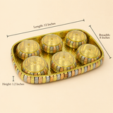 A six-piece gold-plated brass idol tray with detailed silver and copper accents, shown with dimension lines indicating its measurements: length 12 inches, breadth 8 inches, and height 1.2 inches, on a solid beige background.