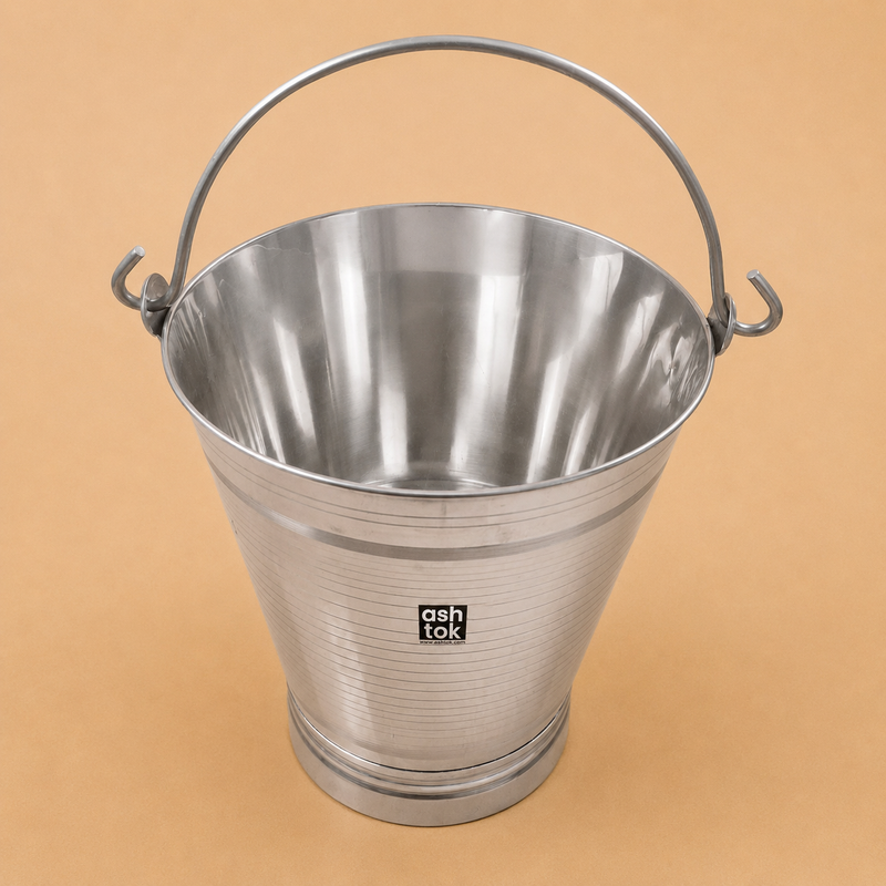 Open stainless steel bathroom bucket with sturdy metal handle on a beige studio background, designed for bathing, water storage, and everyday household use.