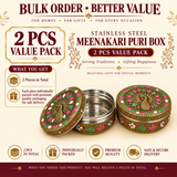 Product promotional graphic for the Stainless Steel Meenakari Puri Box 2 Pcs Value Pack. In the center, two round stainless steel containers are shown: one open with its lid leaning against the side, and one closed displaying a detailed gold-toned peacock lid with vibrant pink and green Meenakari enamel artwork. Surrounding text highlights "2 PCS VALUE PACK", "2 Pieces in Total", "Each piece individually packed with premium quality packaging for safe delivery", and icons for premium quality, individual pack