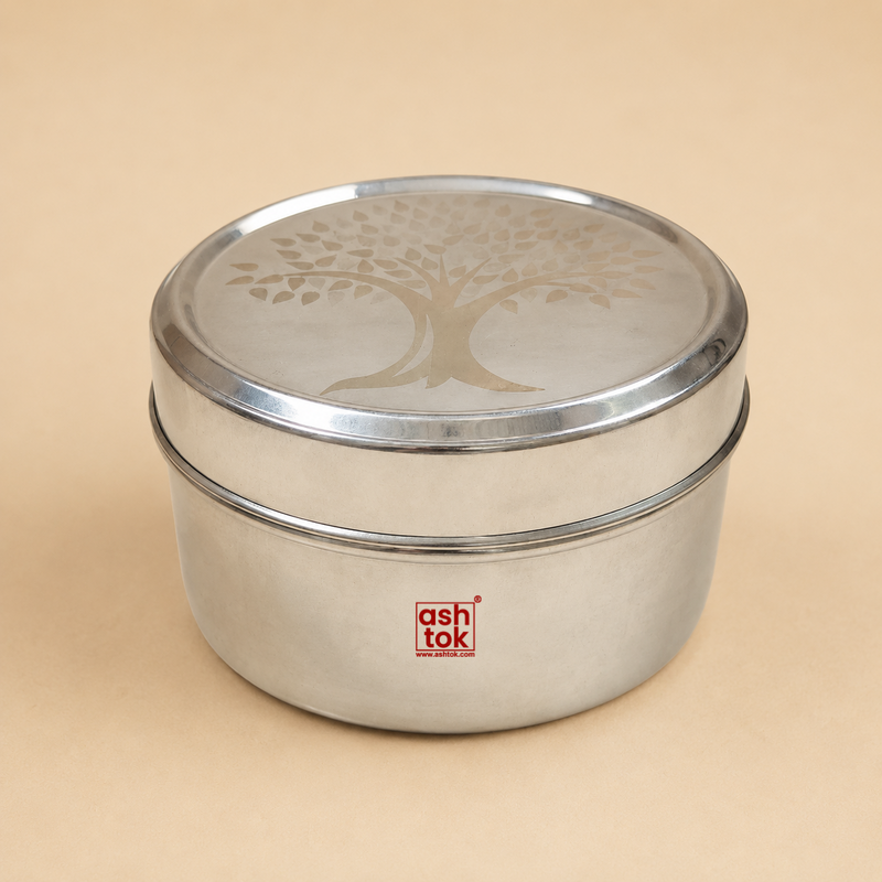Round stainless steel tiffin box with engraved tree design lid, durable food storage container for lunch, snacks, and meal packing.
