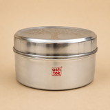Front view of a round stainless steel tiffin box with an engraved tree design lid, reusable food storage container for lunch, snacks, and meal preparation.