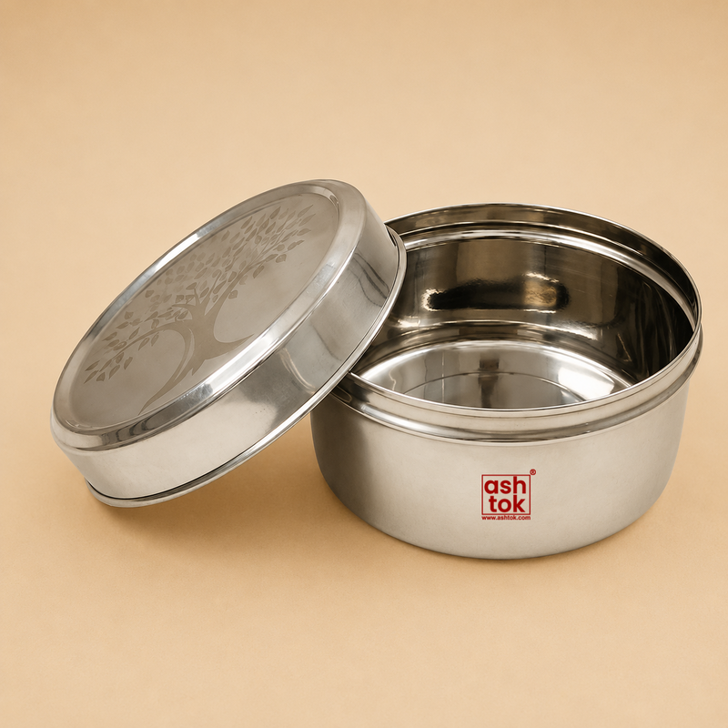 Open round stainless steel tiffin box with engraved tree design lid, durable food storage container for lunch, snacks, and meal preparation.