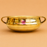 Traditional handcrafted brass urli with side handles, ideal for floating flowers, candles, pooja rituals, Diwali décor, weddings, housewarming, and elegant home decoration.