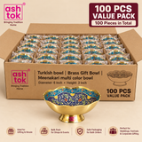 Bulk value pack presentation of 100 Turkish style brass Meenakari gift bowls arranged securely inside a large partitioned cardboard carton for wholesale, event and large-scale gifting requirements. Individual bowls are shown protected in separate compartments while one complete bowl is displayed prominently outside the carton to clearly show the scalloped rim, raised pedestal base, polished golden brass exterior and blue, turquoise, cream, green, yellow and red multicolor Meenakari floral artwork.