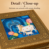 Close-up detail image of the Wood Cow Design Box focusing on the intricate craftsmanship, embossed floral border, textured metallic finish, and central cow and calf artwork. The close-up clearly shows the fine ornamental detailing, traditional design elements, and premium handcrafted appearance of the decorative storage box.
