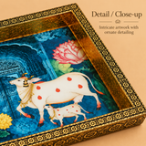 Close-up detail image of the Wood Cow Tray highlighting the traditional cow and calf artwork, lotus motifs, rich blue background, decorative floral frame border, and the fine handcrafted finish of the tray.