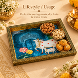 Wood Cow Tray displayed in a festive lifestyle setting, styled for serving sweets, dry fruits, prasad, snacks, or festive treats, showcasing its decorative cow and calf artwork and elegant handcrafted presentation.