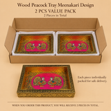 Bulk order 2 pieces value pack graphic for the Wood Peacock Tray Meenakari Design. The image shows an open cardboard shipping box holding 2 rectangular wooden serving trays featuring vibrant pink Meenakari peacock artwork and hammered gold interiors, packed securely side-by-side in white protective liners. A single sample tray rests in the foreground. Informational text indicates '2 PCS VALUE PACK', '2 Pieces in Total', and ensures safe delivery with individual packing.