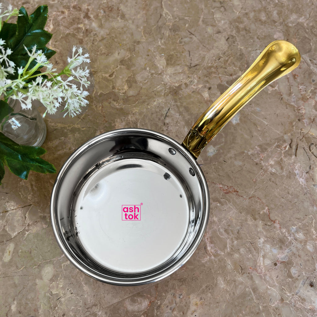 Traditional hammered copper saucepan featuring a brass handle, perfect for preparing sauces, milk, and hot beverages.